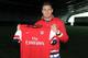 Olivier Giroud proudly holding the Arsenal shirt