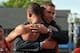 Eaton receives a hug from Dan O'Brien, after breaking his American record for points in the decathlon.