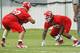 KANSAS CITY, MO - May 13: Ethan Johnson #70 and Dontari Poe #92 of the Kansas City Chiefs work with defensive coach Anthony Pleasant during the Kansas City Chiefs Minicamp on May 13, 2012 at the Chiefs Training Facility in Kansas City, Missouri. (Photo by Kyle Rivas/Getty Images)