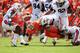 CLEMSON, SC - SEPTEMBER 17: Mike Bellamy #5 of the Clemson Tigers fumbles the ball as he is hit by teammates Jake Holland #5 and Demetruce McNeal #12 of the Auburn Tigers during their game at Memorial Stadium on September 17, 2011 in Clemson, South Carolina. (Photo by Streeter Lecka/Getty Images)