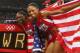LONDON, ENGLAND - AUGUST 10: Carmelita Jeter of the United States, Bianca Knight of the United States, Allyson Felix of the United States and Tianna Madison of the United States celebrate next to the clock after winning gold and setting a new world record of 40.82 afterthe Women's 4 x 100m Relay Final on Day 14 of the London 2012 Olympic Games at Olympic Stadium on August 10, 2012 in London, England. (Photo by Michael Steele/Getty Images)