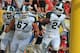 TAMPA, FL - JANUARY 02: Running back Le'Veon Bell #24, wide receiver B. J. Cunningham #3 and guard Chris McDonald #67 of the Michigan State Spartans celebrate a touchdown run against the Georgia Bulldogs in the Outback Bowl January 2, 2012 at Raymond James Stadium in Tampa, Florida. The Spartans won 33 - 30. (Photo by Al Messerschmidt/Getty Images)