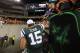 Aug 10, 2012; Cincinnati, OH, USA; New York Jets quarterback Tim Tebow (15) hands a young fan his wrist band after the game against the Cincinnati Bengals at Paul Brown Stadium. The Bengals beat the Jets 17-6. Mandatory Credit: Matthew Emmons-US PRESSWIRE