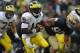 SOUTH BEND, IN - SEPTEMBER 11: Denard Robinson #16 of the Michigan Wolverines runs past Ethan Johnson #90 of the Notre Dame Fighting Irish at Notre Dame Stadium on September 11, 2010 in South Bend, Indiana. Michigan defeated Notre Dame 28-24. (Photo by Jonathan Daniel/Getty Images)