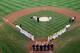 SOUTH WILLIAMSPORT, PA - AUGUST 28: Members of the Japan team from Hamamatsu City, Japan (L) and the West team from Huntington Beach, California line up before the start of the Little League World Series championship game on August 28, 2011 in South Williamsport, Pennsylvania. The West team defeated the team from Japan 2-1. (Photo by Rob Carr/Getty Images)