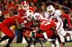 CHARLOTTE, NC - DECEMBER 27: Victor Anderson #20 of the Louisville Cardinals is tackled by Earl Wolff #27 of the North Carolina State Wolfpack during their game at Bank of America Stadium on December 27, 2011 in Charlotte, North Carolina. (Photo by Streeter Lecka/Getty Images)