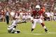 Ryan Williams (right) eludes an Oakland defender in the first quarter.