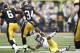 IOWA CITY, IA - NOVEMBER 5: Marcus Coker #34 of the Iowa Hawkeyes runs over Troy Woolfolk #29 of the Michigan Wolverines during first half action at Kinnick Stadium on November 5, 2011 in Iowa City, Iowa. (Photo by Joe Robbins/Getty Images)