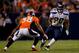 DENVER, CO - AUGUST 18: Running back Kregg Lumpkin #20 of the Seattle Seahawks looks to make a move past cornerback Ramzee Robinson #38 of the Denver Broncos during the fourth quarter at Sports Authority Field Field at Mile High on August 18, 2012 in Denver, Colorado. The Seahawks defeated the Broncos 30-10. (Photo by Justin Edmonds/Getty Images)