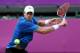 LONDON, ENGLAND - AUGUST 02: John Isner of the United States returns a shot to Roger Federer of Switzerland during the Quarterfinal of Men's Singles Tennis on Day 6 of the London 2012 Olympic Games at Wimbledon on August 2, 2012 in London, England. (Photo by Clive Brunskill/Getty Images)
