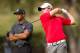 Dec 3, 2010; Thousand Oaks, CA, USA; Rory McIlroy (right) hits his tee shot on the fifth hole while Tiger Woods (right) looks on during the second round of the Chevron World Challenge at Sherwood Country Club. Mandatory Credit: Allan Henry-US PRESSWIRE