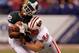 INDIANAPOLIS, IN - DECEMBER 03: Keshawn Martin #82 of the Michigan State Spartans loses his helmet as he is hit by Chris Borland #44 of the Wisconsin Badgers during the third quarter of the Big 10 Conference Championship Game at Lucas Oil Stadium on December 3, 2011 in Indianapolis, Indiana. (Photo by Gregory Shamus/Getty Images)