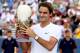 MASON, OH - AUGUST 19: Roger Federer of Switzerland celebrates with the winner's trophy after defeatng Novak Djokovic of Serbia during the final of the Western & Southern Open at the Lindner Family Tennis Center on August 19, 2012 in Mason, Ohio. (Photo by Matthew Stockman/Getty Images)