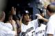 MILWAUKEE, WI - AUGUST 08: Carlos Gomez #27 of the Milwaukee Brewers celebrates in the dugout after hitting a solo home run in the bottom of the 6th inning against the Cincinnati Reds at Miller Park on August 08, 2012 in Milwaukee, Wisconsin. (Photo by Mike McGinnis/Getty Images)