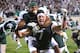EAST LANSING, MI - OCTOBER 22: B.J. Cunningham #3 and Keith Nichol #7 of the Michigan State Spartans celebrate Nichol catching a game-winning 44 yard touchdown pass from Kirk Cousins #8 as time ran out to defeat the Wisconsin Badgers 37-31 at Spartan Stadium on October 22, 2011 in East Lansing, Michigan. (Photo by Mark Cunningham/Getty Images)
