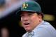 DENVER, CO - JUNE 12: Starting pitcher Bartolo Colon #21 of the Oakland Athletics looks on from the dugout as he earned the win against the Colorado Rockies in an 8-5 win during Interleague Play at Coors Field on June 12, 2012 in Denver, Colorado. (Photo by Doug Pensinger/Getty Images)