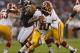 CHICAGO, IL - AUGUST 18: Robert Griffin III #10 of the Washington Redskins rolls out to look for a receiver against the Chicago Bears during a preseason game at Soldier Field on August 18, 2012 in Chicago, Illinois. (Photo by Jonathan Daniel/Getty Images)