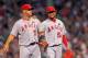 FOXBORO, MA - AUGUST 21: Albert Pujols #5 and Ervin Santana #54 of the Los Angeles Angels share a laugh after Santana had trouble fielding a ball during a game with the Boston Red Sox at Fenway Park on August 21, 2012 in Boston, Massachusetts. (Photo by Jim Rogash/Getty Images)