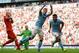 Carlos Tevez celebrates his late goal which earned Manchester City a draw against Liverpool at Anfield.