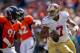 DENVER, CO - AUGUST 26: Quarterback Colin Kaepernick #7 of the San Francisco 49ers tries to elude defensive end Robert Ayers #91 of the Denver Broncos during the third quarter of a pre-season game at Sports Authority Field Field at Mile High on August 26, 2012 in Denver, Colorado. The 49ers defeated the Broncos, 29-24. (Photo by Justin Edmonds/Getty Images)