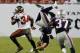 Former Buc Niko Koutouvides flips over Michael Smith. (photo courtesy Buccaneers.com)