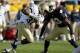 SOUTH BEND, IN - OCTOBER 29: John Howell #33 of the Navy Midshipmen runs against Josh Atkinson #43 of the Notre Dame Fighting Irish.at Notre Dame Stadium on October 29, 2011 in South Bend, Indiana. Notre Dame defeated Navy 56-14. (Photo by Jonathan Daniel/Getty Images)
