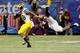 NEW ORLEANS, LA - JANUARY 03: Fitzgerald Toussaint #28 of the Michigan Wolverines runs with the ball against Tariq Edwards #24 of the Virginia Tech Hokies during the Allstate Sugar Bowl at Mercedes-Benz Superdome on January 3, 2012 in New Orleans, Louisiana. (Photo by Kevin C. Cox/Getty Images)