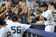 NEW YORK, NY - AUGUST 19: Ichiro Suzuki #31 of the New York Yankees (R) celebrates with his teammates after he connects on a solo home run in the fourth inning against the Boston Red Sox at Yankees Stadium on August 19, 2012 in the Bronx borough of New York City. (Photo by Jason Szenes/Getty Images)