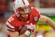 LINCOLN, NE - NOVEMBER 05: Running back Rex Burkhead #22 of the Nebraska Cornhuskers slips through the Northwestern Wildcats defense during their game at Memorial Stadium November 5, 2011 in Lincoln, Nebraska. Northwestern beat Nebraska 28-25. (Photo by Eric Francis/Getty Images)
