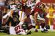 LANDOVER, MD - AUGUST 29: Running back Roy Helu #29 of the Washington Redskins drags Jacob Cutrera #51 of the Tampa Bay Buccaneers as he scores during the second half at FedExField on August 29, 2012 in Landover, Maryland. (Photo by Rob Carr/Getty Images)