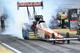 Burnout time for Don Schumacher Racing in NHRA Top Fuel. Credit: Gary Larsen at Racetake.com