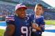 ORCHARD PARK, NY - OCTOBER 09:Dwan Edwards #98 of the Buffalo Bills carries his son DJ off the field after playing the Philadelphia Eagles on October 9, 2011 in Orchard Park, New York. Buffalo woin 31-24. (Photo by Rick Stewart/Getty Images)