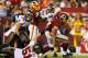 LANDOVER, MD - AUGUST 29: Running back Roy Helu #29 of the Washington Redskins drags Jacob Cutrera #51 of the Tampa Bay Buccaneers as he scores during the second half at FedExField on August 29, 2012 in Landover, Maryland. (Photo by Rob Carr/Getty Images)