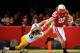 LINCOLN, NE - NOVEMBER 25: Running back Rex Burkhead #22 of the Nebraska Cornhuskers stiff-arms defensive back Tanner Miller #5 of the Iowa Hawkeyes during their game at Memorial Stadium November 25, 2011 in Lincoln, Nebraska. (Photo by Eric Francis/Getty Images)