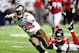 ATLANTA, GA - JANUARY 01: Thomas DeCoud #28 of the Atlanta Falcons dives to tackle Mike Williams #19 of the Tampa Bay Buccaneers during play at the Georgia Dome on January 1, 2012 in Atlanta, Georgia. The Falcons won 45-24. (Photo by Grant Halverson/Getty Images)