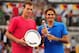 MADRID, SPAIN - MAY 13: Tomas Berdych of Czech Republic holds the runners up plate as Roger Federer of Switzerland holds the winner's trophy after the Men's Single Final on Day Nine of the Mutua Madrilena Madrid Open at the Caja Magica on May 13, 2012 in Madrid, Spain. (Photo by Mike Hewitt/Getty Images)