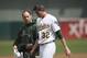September 5, 2012; Oakland, CA, USA; Oakland Athletics starting pitcher Brandon McCarthy (32) leaves the field with a trainer after being hit in the head on a line drive by Los Angeles Angels shortstop Erick Aybar (not pictured) during the fourth inning at O.co Coliseum. Mandatory Credit: Kelley L Cox-US PRESSWIRE