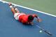 NEW YORK, NY - SEPTEMBER 06: Janko Tipsarevic of Serbia slips on the court against David Ferrer of Spain during their men's singles quarterfinal match on Day Eleven of the 2012 U.S. Open at the USTA Billie Jean King National Tennis Center on September 6, 2012 in the Flushing neighborhood, of the Queens borough of New York City. (Photo by Mike Stobe/Getty Images for USTA)