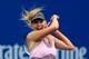 NEW YORK, NY - SEPTEMBER 05: Maria Sharapova of Russia returns a shot against Marion Bartoli of France during their women's singles quarterfinal match on Day Ten of the 2012 U.S. Open at the USTA Billie Jean King National Tennis Center on September 5, 2012 in the Flushing neighborhood, of the Queens borough of New York City. (Photo by Chris Trotman/Getty Images for USTA)