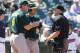 CLEVELAND, OH - AUGUST 30: Manager Bob Melvin #6 and Seth Smith #15 of the Oakland Athletics argue strike three with home plate umpire umpire Paul Emmel #50 during the fifth inning against the Cleveland Indians at Progressive Field on August 30, 2012 in Cleveland, Ohio. (Photo by Jason Miller/Getty Images)