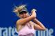 NEW YORK, NY - SEPTEMBER 05: Maria Sharapova of Russia returns a shot against Marion Bartoli of France during their women's singles quarterfinal match on Day Ten of the 2012 U.S. Open at the USTA Billie Jean King National Tennis Center on September 5, 2012 in the Flushing neighborhood, of the Queens borough of New York City. (Photo by Chris Trotman/Getty Images for USTA)