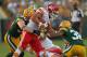 GREEN BAY, WI - AUGUST 30: Peyton Hillis #40 of the Kansas City Chiefs is tackled A.J. Hawk #50 and Tramon Williams #38 of the Green Bay Packers during a preseason game at Lambeau Field on August 30, 2012 in Green Bay, Wisconsin. The Packers defeated the Chiefs 24-3. (Photo by Jonathan Daniel/Getty Images)