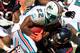 MIAMI GARDENS, FL - SEPTEMBER 18: Reggie Bush #22 of the Miami Dolphins is tackled by Earl Mitchell #92 of the Houston Texans during a game at Sun Life Stadium on September 18, 2011 in Miami Gardens, Florida. (Photo by Sam Greenwood/Getty Images)