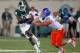 EAST LANSING, MI - AUGUST 31: Tony Lippett #14 of the Michigan State Spartans tries to avoid the tackle of Tyler Horn #69 of the Boise State Broncos during a third quarter reverse at Spartan Stadium on August, 2010 in East Lansing, Michigan. Michigan State won the game 17-13. (Photo by Gregory Shamus/Getty Images)