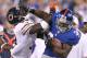 EAST RUTHERFORD, NJ - AUGUST 24: David Wilson #34 of the New York Giants is shoves by Charles Tillman #33 of the Chicago Bears during a preseason game on August 24, 2012 at MetLife Stadium in East Rutherford, New Jersey. (Photo by Elsa/Getty Images)