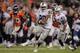 Darren McFadden carries the ball against the Denver Broncos