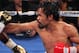 LAS VEGAS, NV - JUNE 09: (R-L) Manny Pacquiao lands a right to the head of Timothy Bradley during their WBO welterweight title fight at MGM Grand Garden Arena on June 9, 2012 in Las Vegas, Nevada. (Photo by Jeff Bottari/Getty Images)