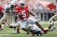 COLUMBUS, OH - SEPTEMBER 8: Braxton Miller #5 of the Ohio State Buckeyes is sacked by Jonathan Davis #11 of the Central Florida Knights on September 8, 2012 at Ohio Stadium in Columbus, Ohio. Ohio defeated Central Florida 31-16. (Photo by Kirk Irwin/Getty Images)