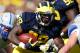 ANN ARBOR, MI - SEPTEMBER 08: Fitzgerald Toussaint #28 of the Michigan Wolverines looks to get around the tackle of Brian Lindsay #31 of the Air Force Falcons during a first quarter run at Michigan Stadium on September 8, 2012 in Ann Arbor, Michigan. (Photo by Gregory Shamus/Getty Images)