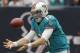 HOUSTON,TX - SEPTEMBER 09: Ryan Tannehill #17 of the Miami Dolphins fumbles the snap in the first quarter against the Houston Texans during the season opener at Reliant Stadium on September 9, 2012 in Houston, Texas. (Photo by Bob Levey/Getty Images)